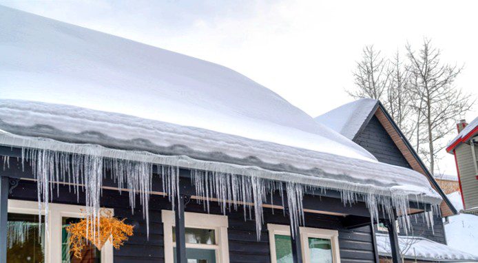 snowy roof with hanging icicles