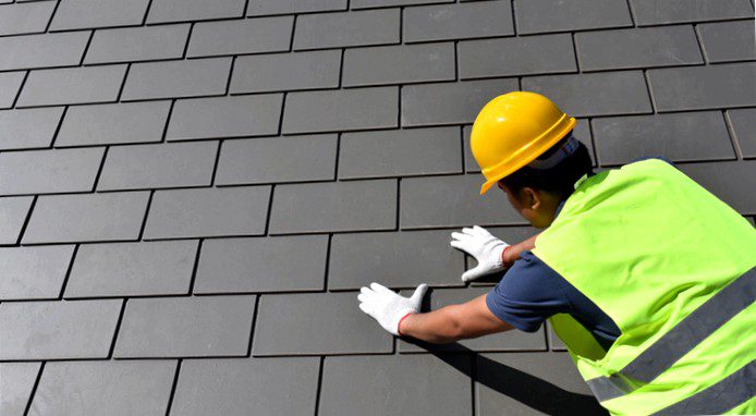 worker installing slate roof